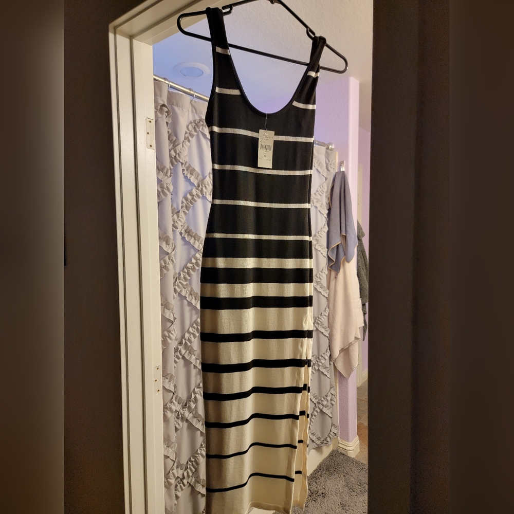 Never been worn black and white dress with side slit, in excellent condition.